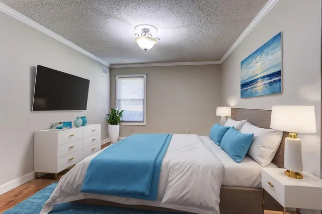 a bedroom with a bed and a flat screen tv