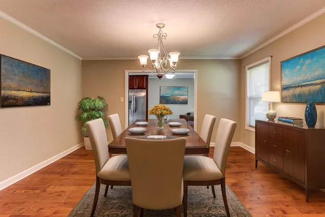 a dining room with furniture and window