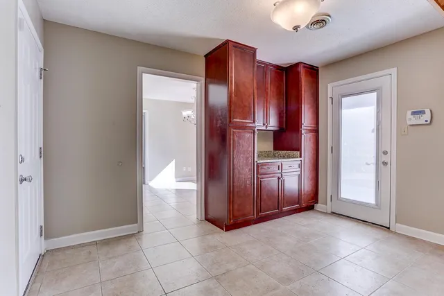 an empty room with a cabinet and mirrors