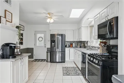 a kitchen with a sink stainless steel appliances and cabinets
