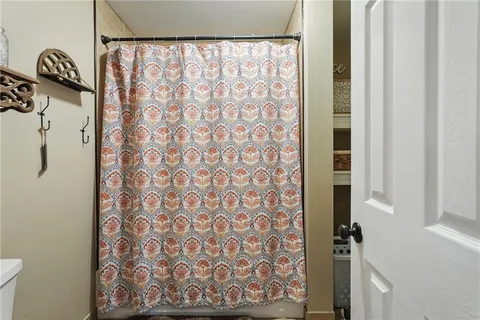 a bathroom with a shower curtain and a sink