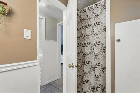 a view of bathroom with shower curtain