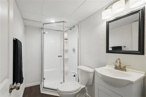 a bathroom with a toilet a sink and shower
