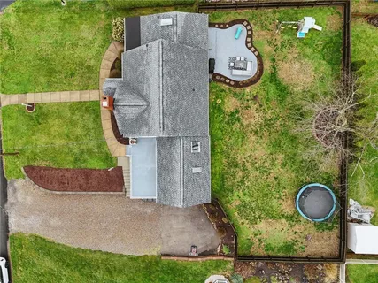 an aerial view of a house with outdoor space