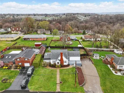 an aerial view of a houses with outdoor space and lake view
