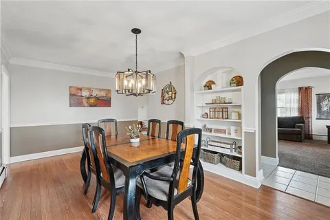 a view of a dining room with furniture wooden floor and chandelier