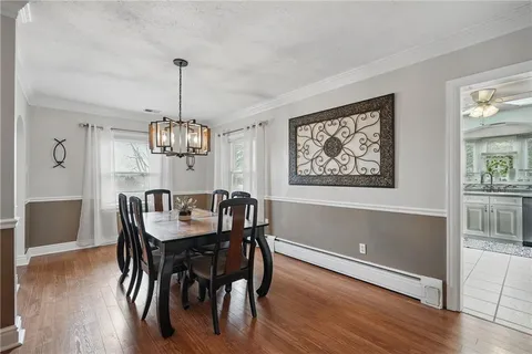a view of a dining room with furniture wooden floor and chandelier