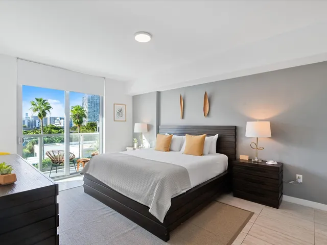 a large bedroom with a bed and glass window