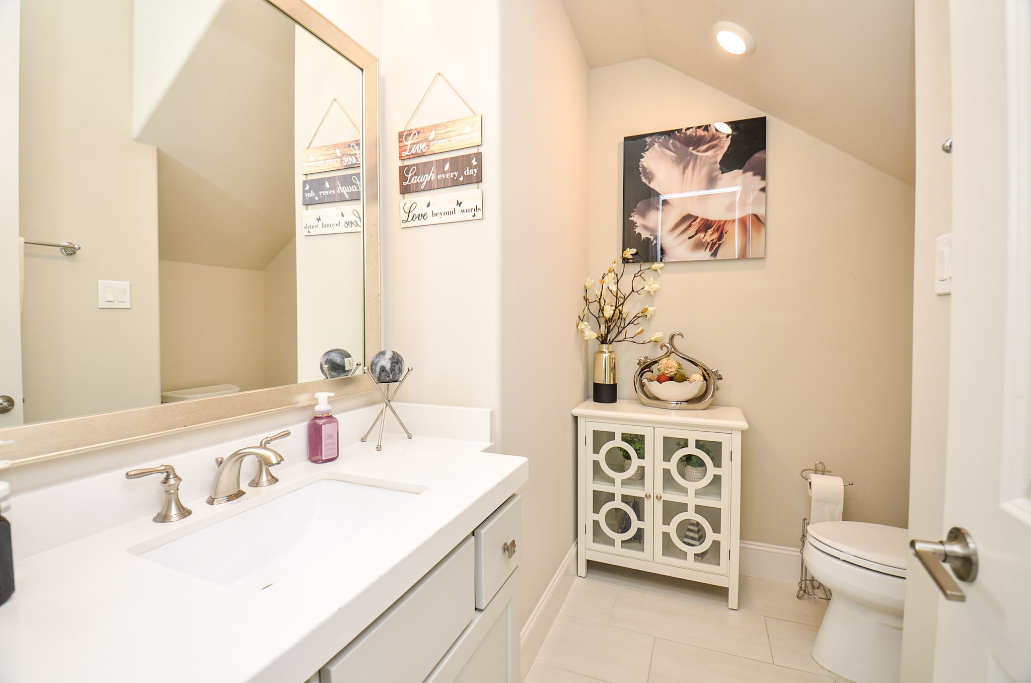 2431 Prairie Hollow Lane Houston, TX 77077 - Photo 6 of 31 a bathroom with a sink a toilet and a mirror