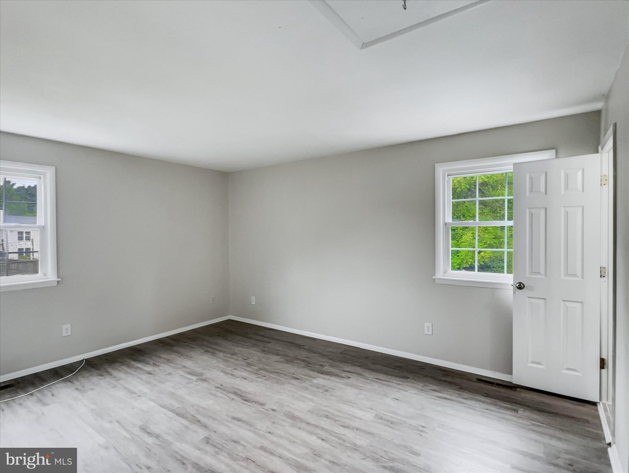 2618 Jonathan Road Ellicott City, MD 21042 - Photo 11 of 32 wooden floor in an empty room with a window