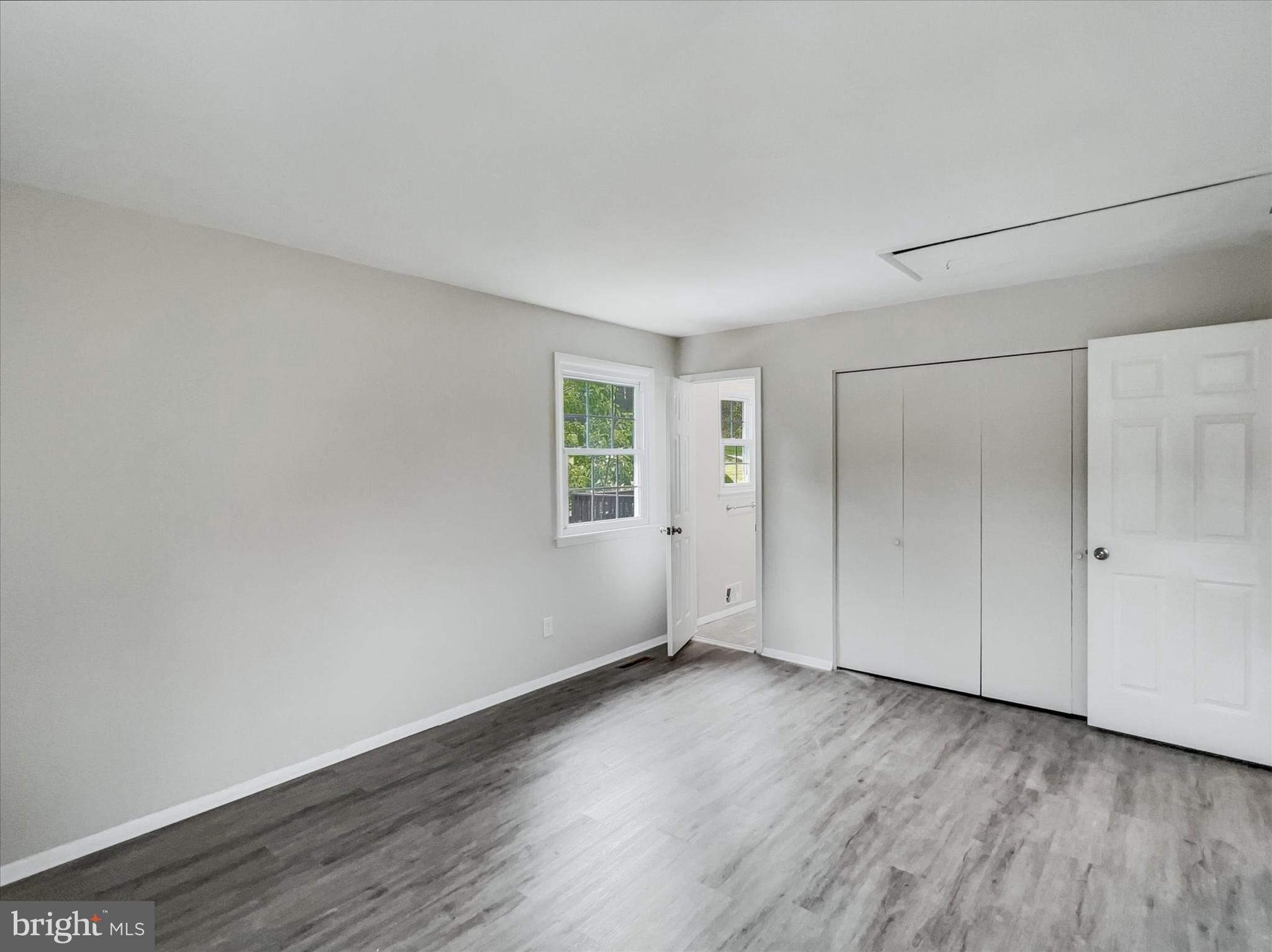 2618 Jonathan Road Ellicott City, MD 21042 - Photo 13 of 32 a view of an empty room with wooden floor and a window