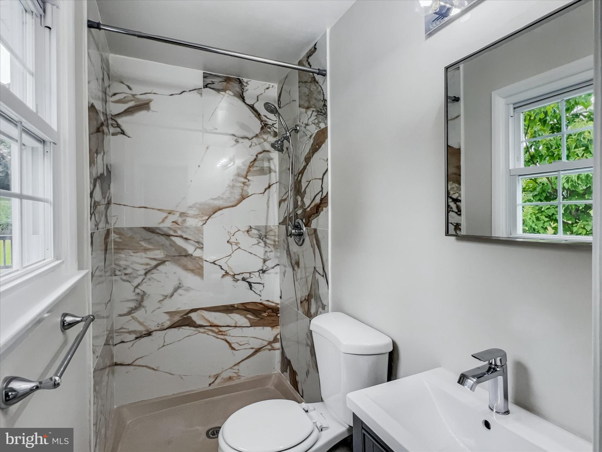 2618 Jonathan Road Ellicott City, MD 21042 - Photo 14 of 32 a bathroom with a sink toilet and shower