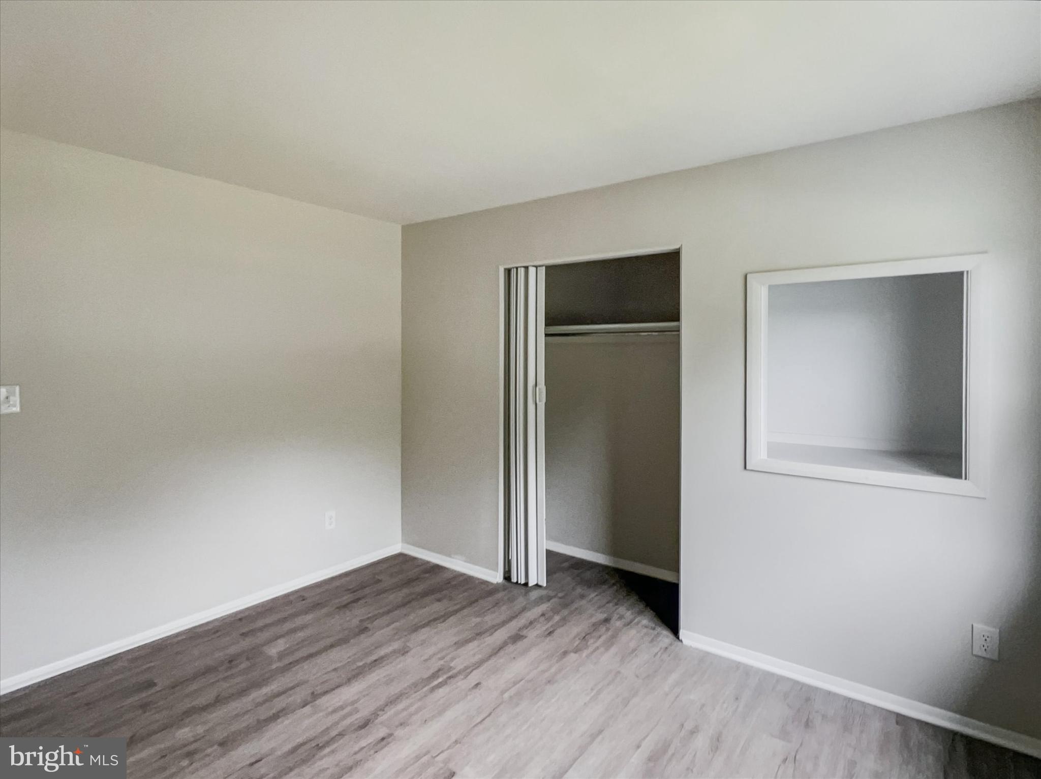 2618 Jonathan Road Ellicott City, MD 21042 - Photo 17 of 32 an empty room with wooden floor and closet