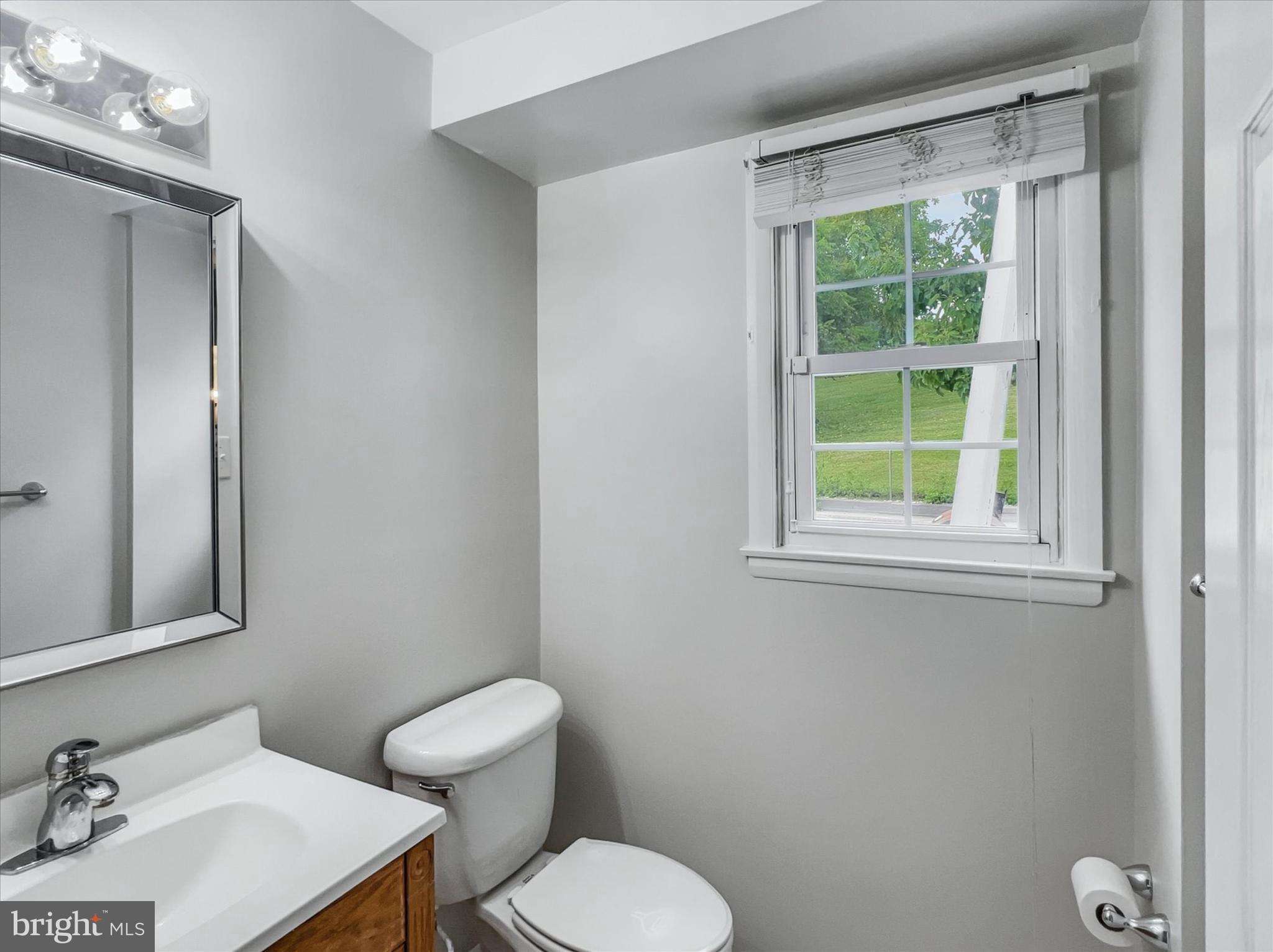 2618 Jonathan Road Ellicott City, MD 21042 - Photo 23 of 32 a bathroom with a toilet sink and mirror