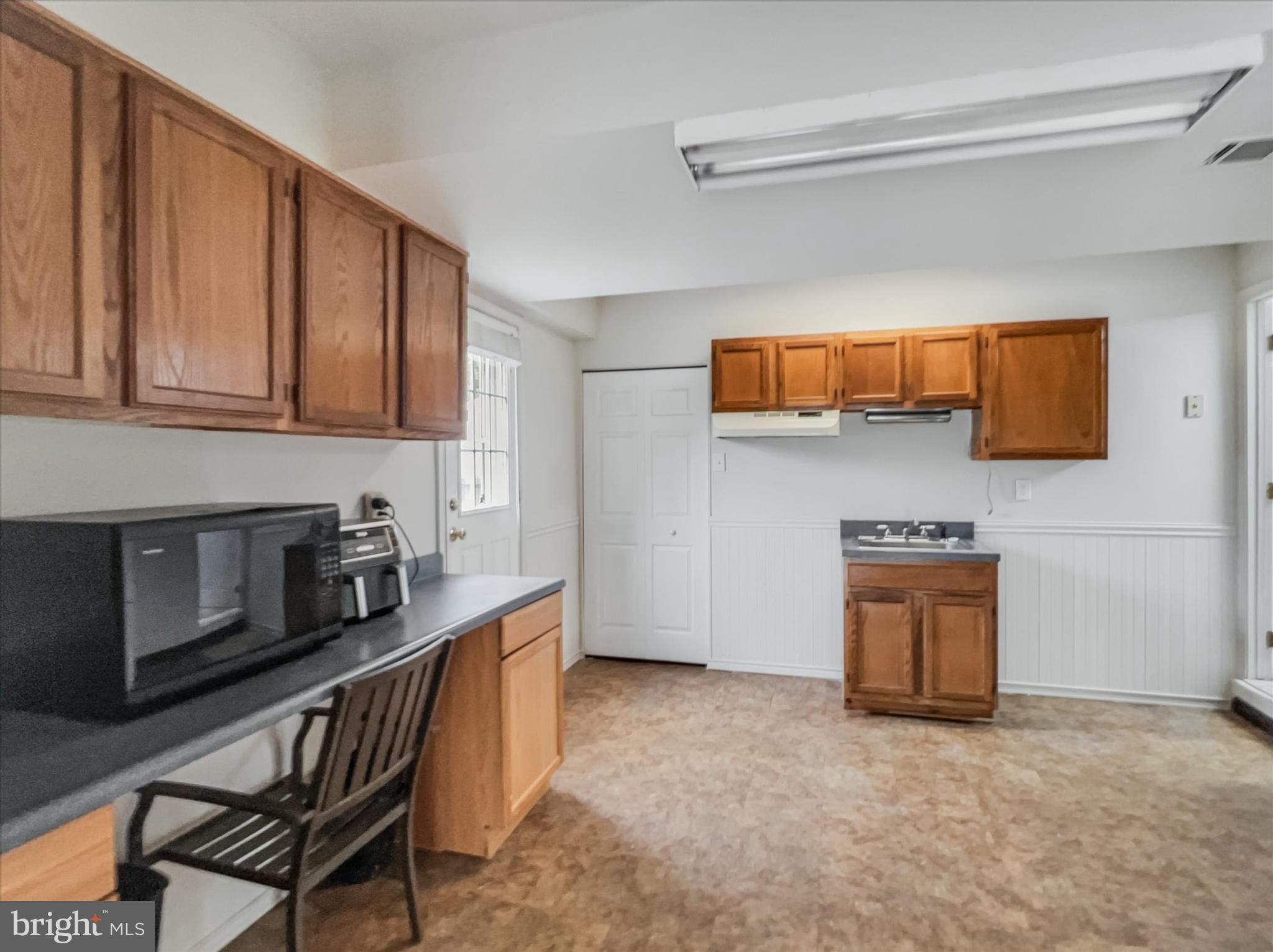 2618 Jonathan Road Ellicott City, MD 21042 - Photo 26 of 32 a kitchen with stainless steel appliances granite countertop a stove a sink and a microwave