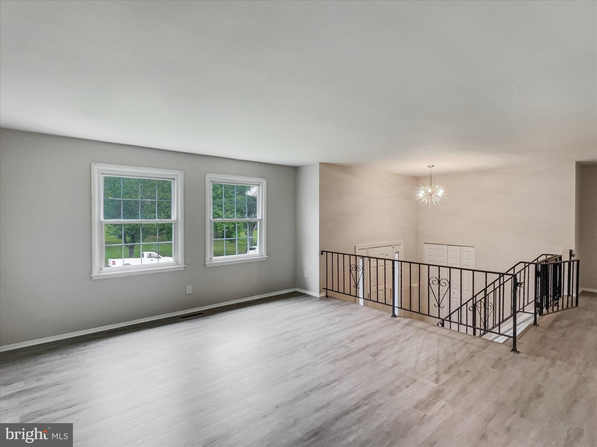 2618 Jonathan Road Ellicott City, MD 21042 - Photo 4 of 32 a view of an empty room with wooden floor and a window