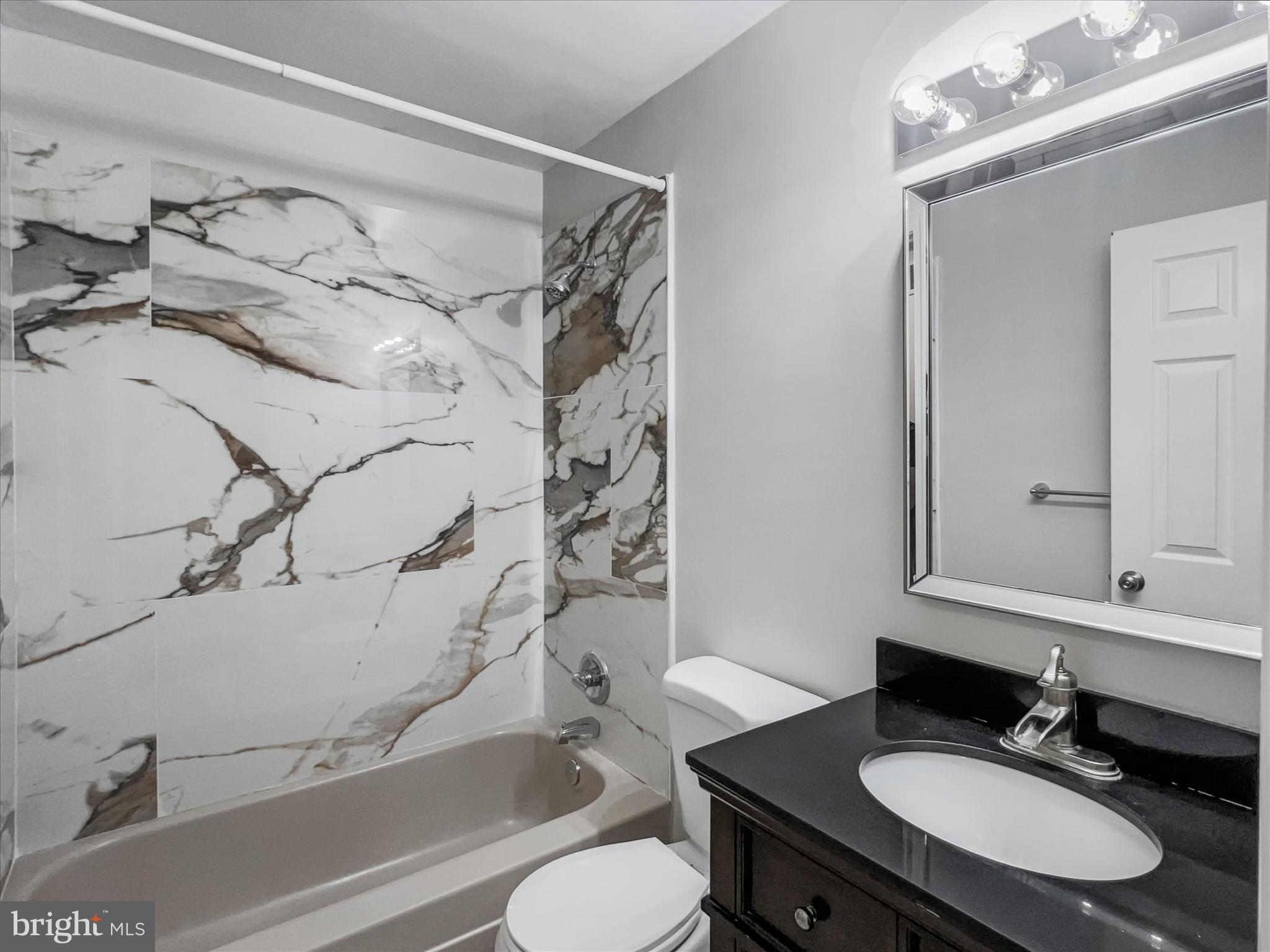 2618 Jonathan Road Ellicott City, MD 21042 - Photo 10 of 32 a bathroom with a sink vanity mirror and toilet