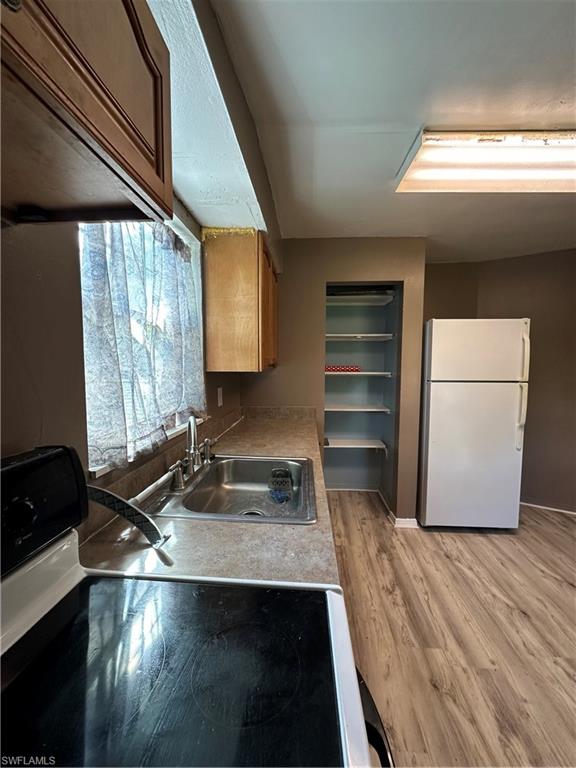 18301 Slater Road North Fort Myers, FL 33917 - Photo 4 of 17 a kitchen with a refrigerator and a stove