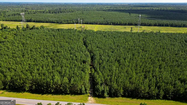 a view of a green field with an outdoor space