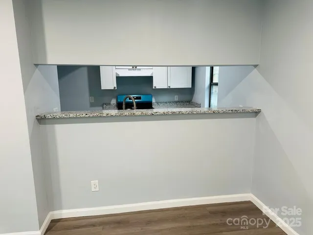 a view of kitchen with stainless steel appliances granite countertop refrigerator sink and stove
