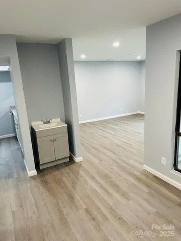 a utility room with wooden floor washer and dryer