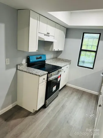 a kitchen with sink and mirror