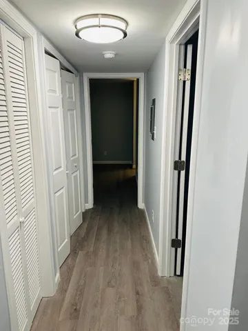 a view of pool with tress in front of house