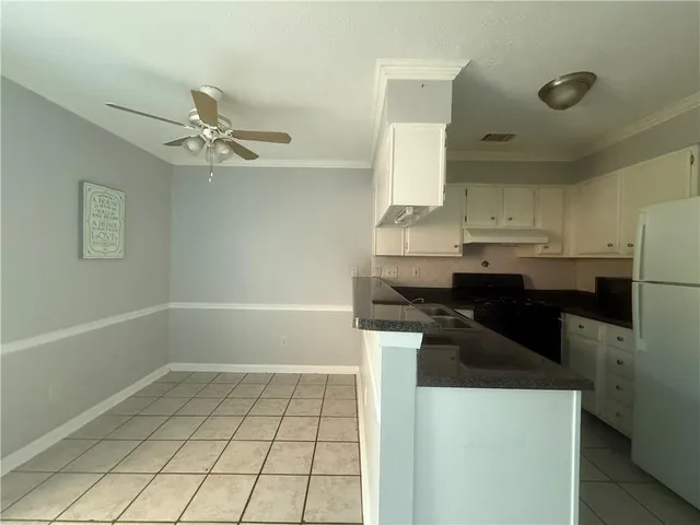a kitchen with a sink a stove and cabinets