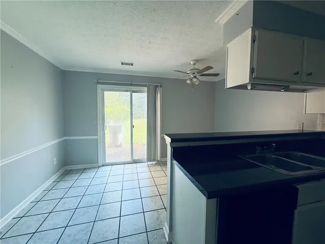a view of a kitchen with a sink and cabinets