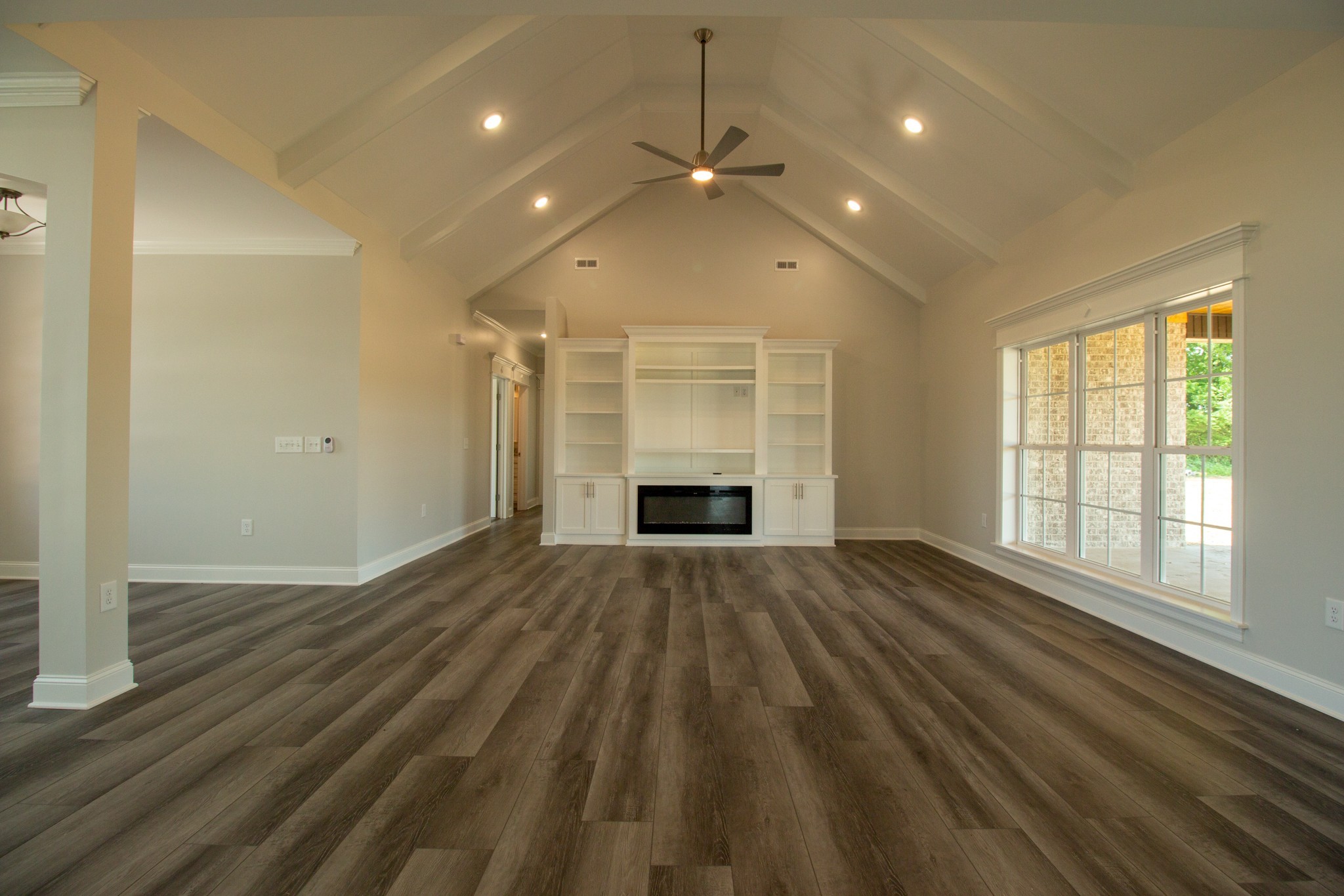 935 South Cross Bridges Road Mount Pleasant, TN 38474 - Photo 11 of 44 an empty room with wooden floor fireplace and windows