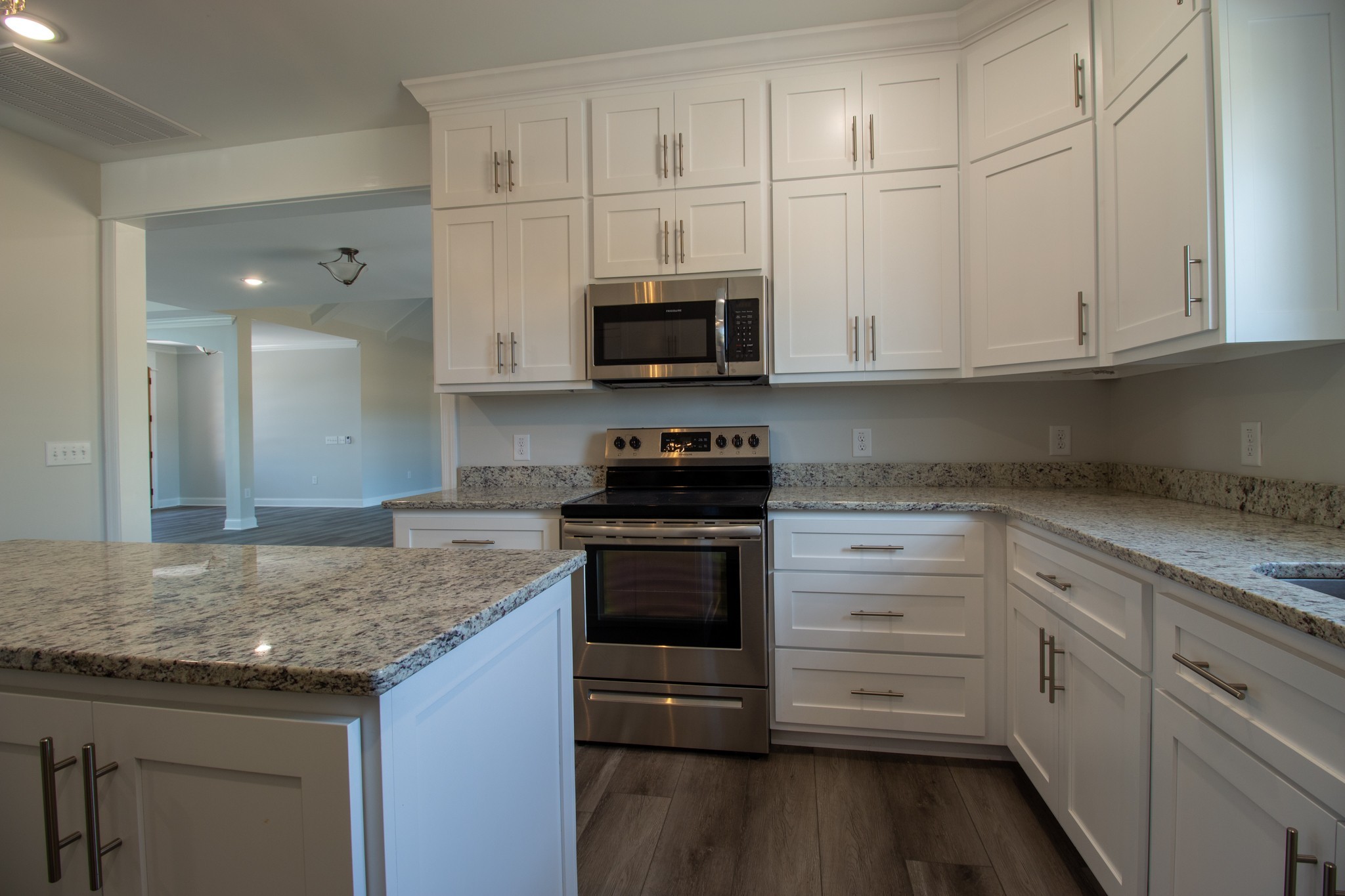 935 South Cross Bridges Road Mount Pleasant, TN 38474 - Photo 5 of 44 a kitchen with granite countertop white cabinets and stainless steel appliances