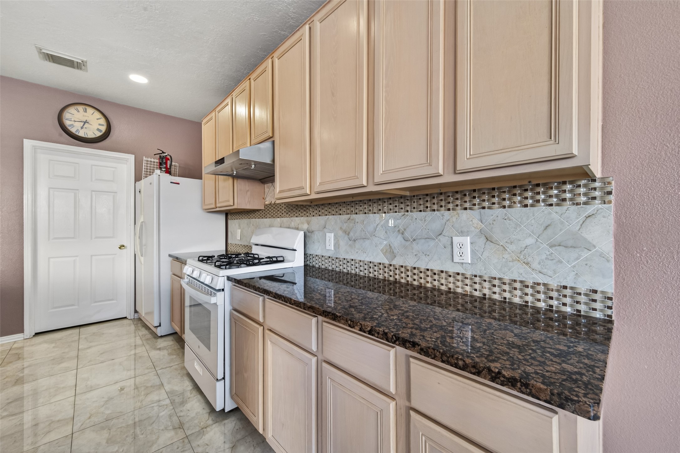18818 Flagstone Creek Road Houston, TX 77084 - Photo 15 of 47 a kitchen with granite countertop a sink stainless steel appliances and cabinets