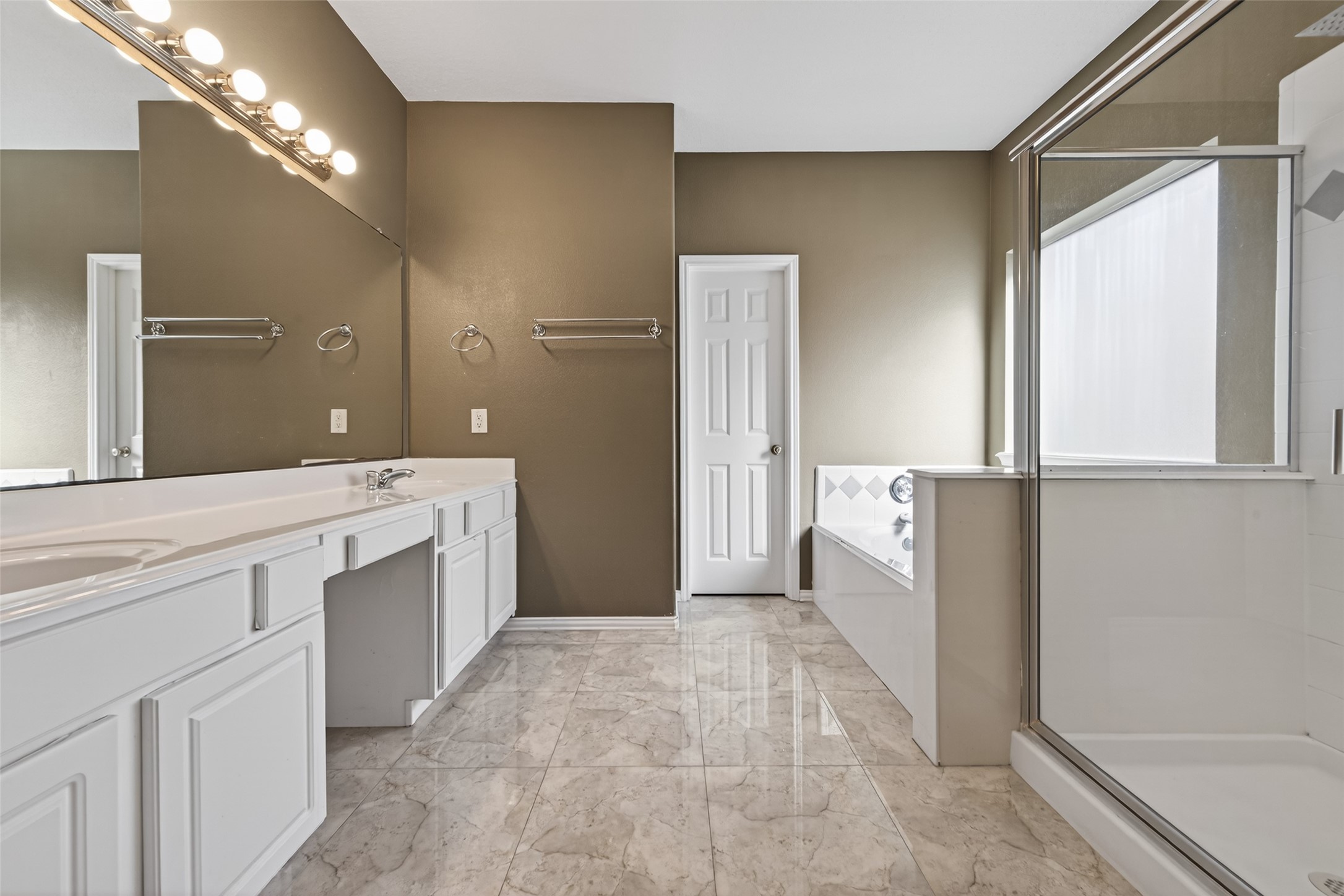 18818 Flagstone Creek Road Houston, TX 77084 - Photo 29 of 47 a spacious bathroom with a double vanity sink a mirror and a shower