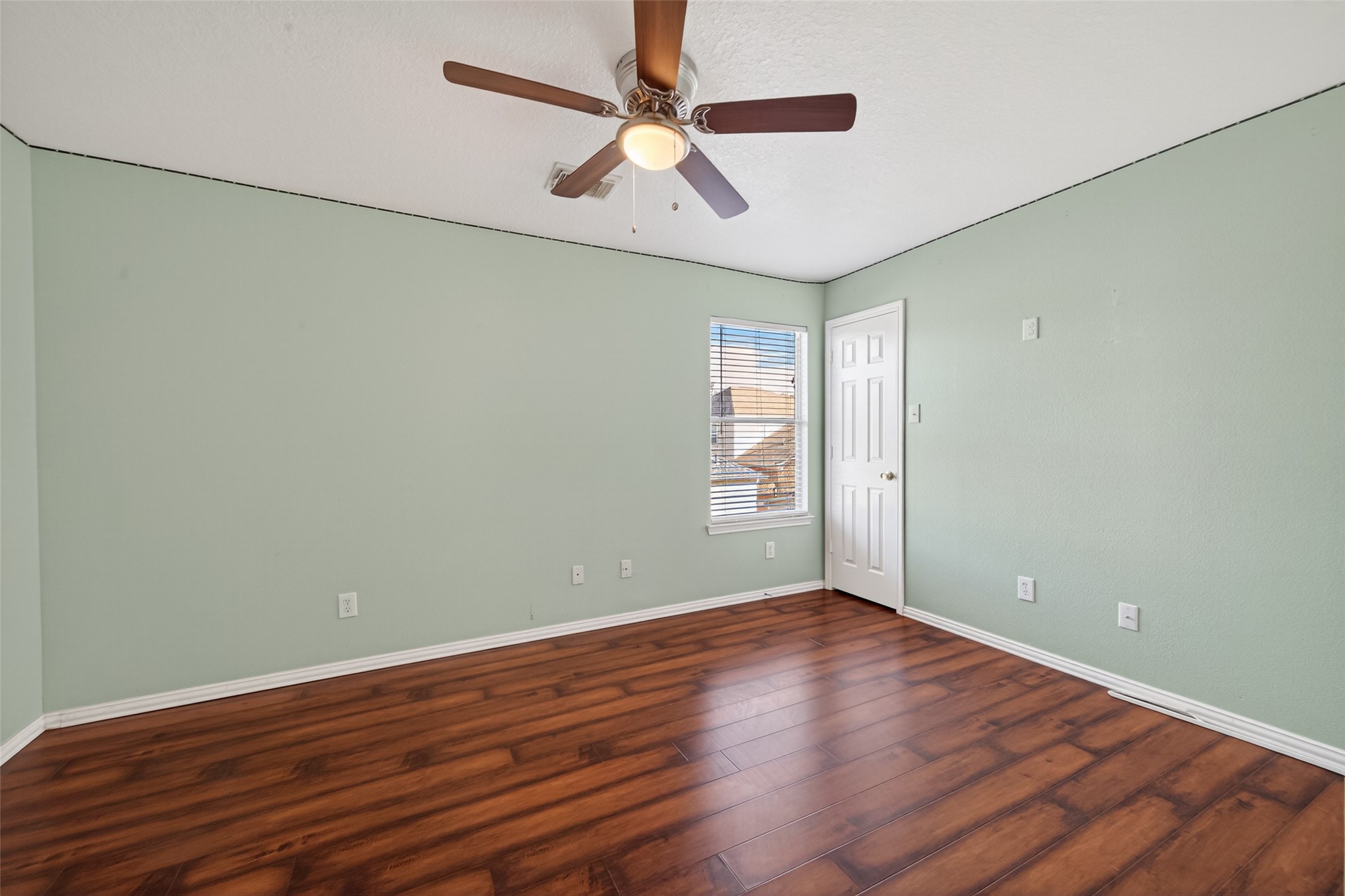 18818 Flagstone Creek Road Houston, TX 77084 - Photo 34 of 47 an empty room with wooden floor fan and windows