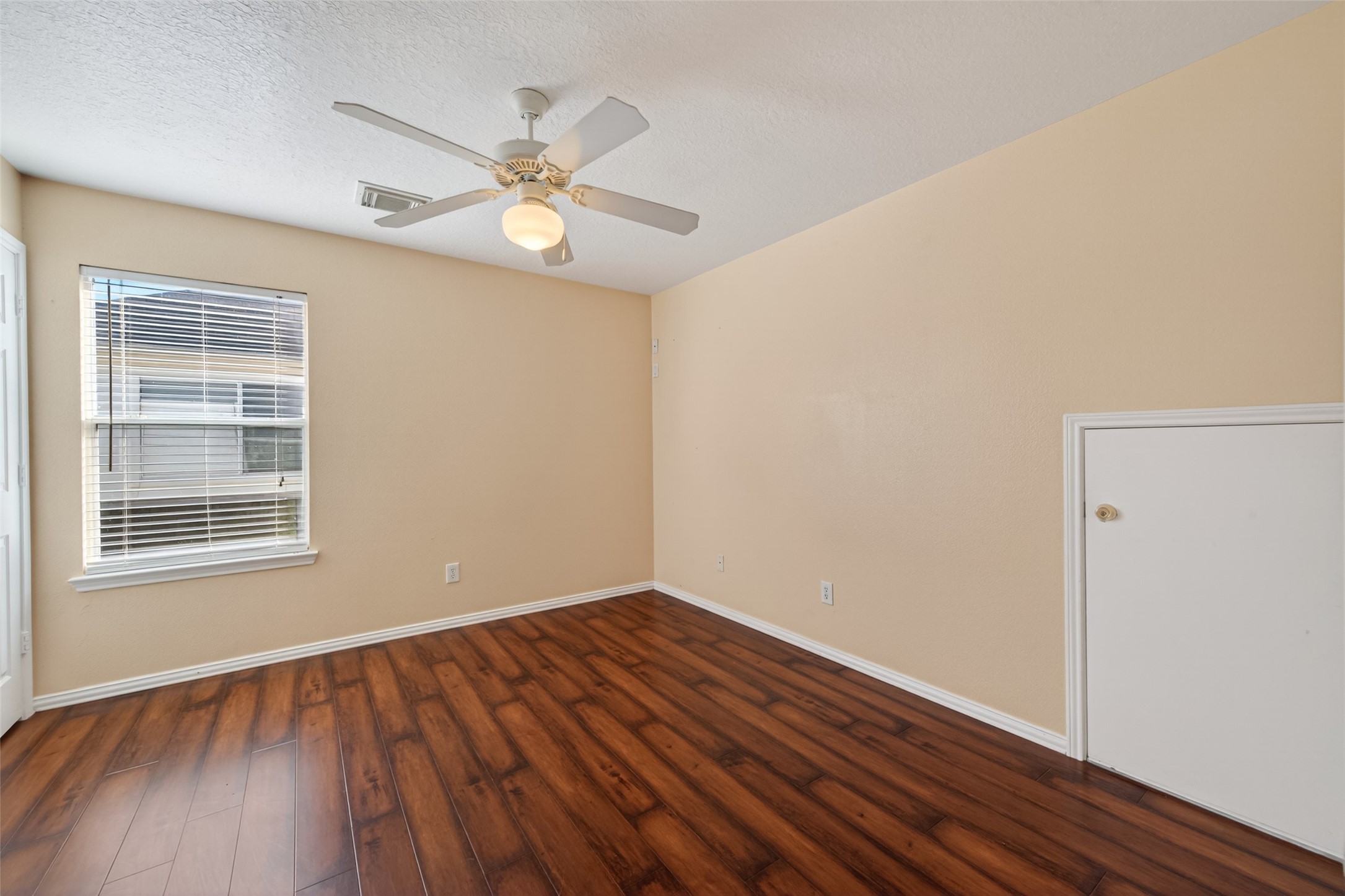 18818 Flagstone Creek Road Houston, TX 77084 - Photo 36 of 47 a view of an empty room with wooden floor and a window