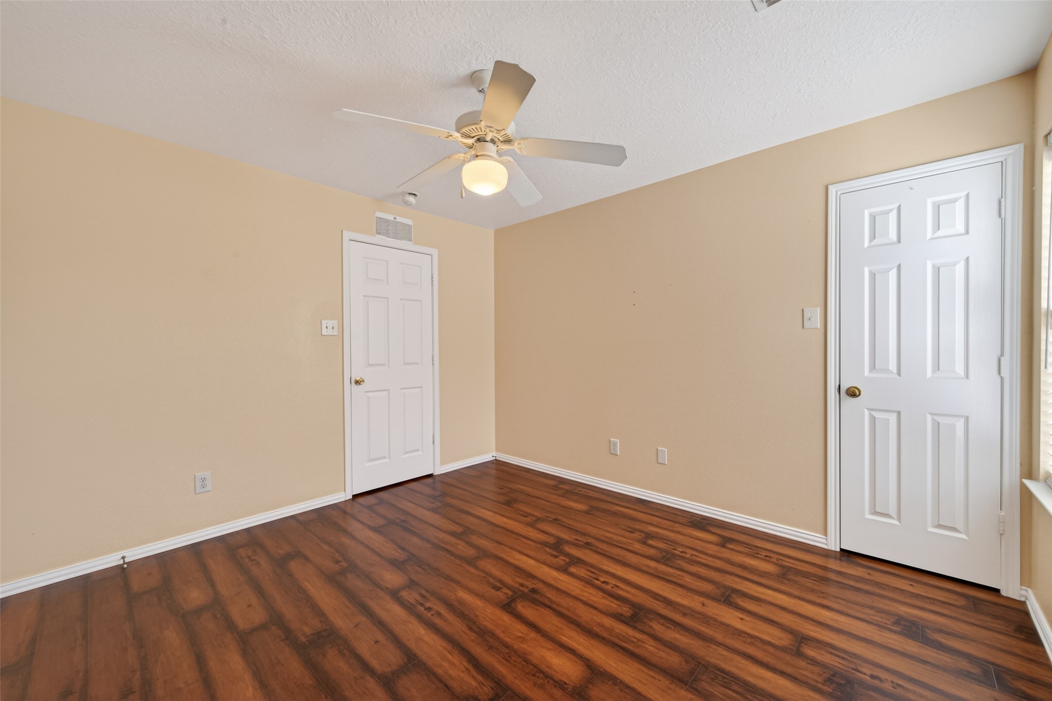 18818 Flagstone Creek Road Houston, TX 77084 - Photo 37 of 47 an empty room with wooden floor fan and windows