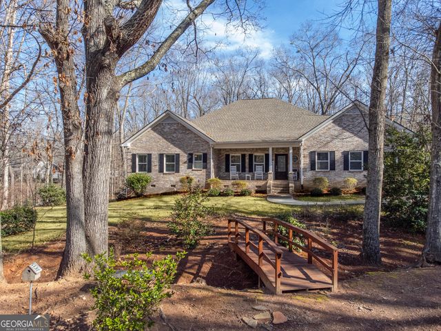 a front view of a house with yard porch and furniture