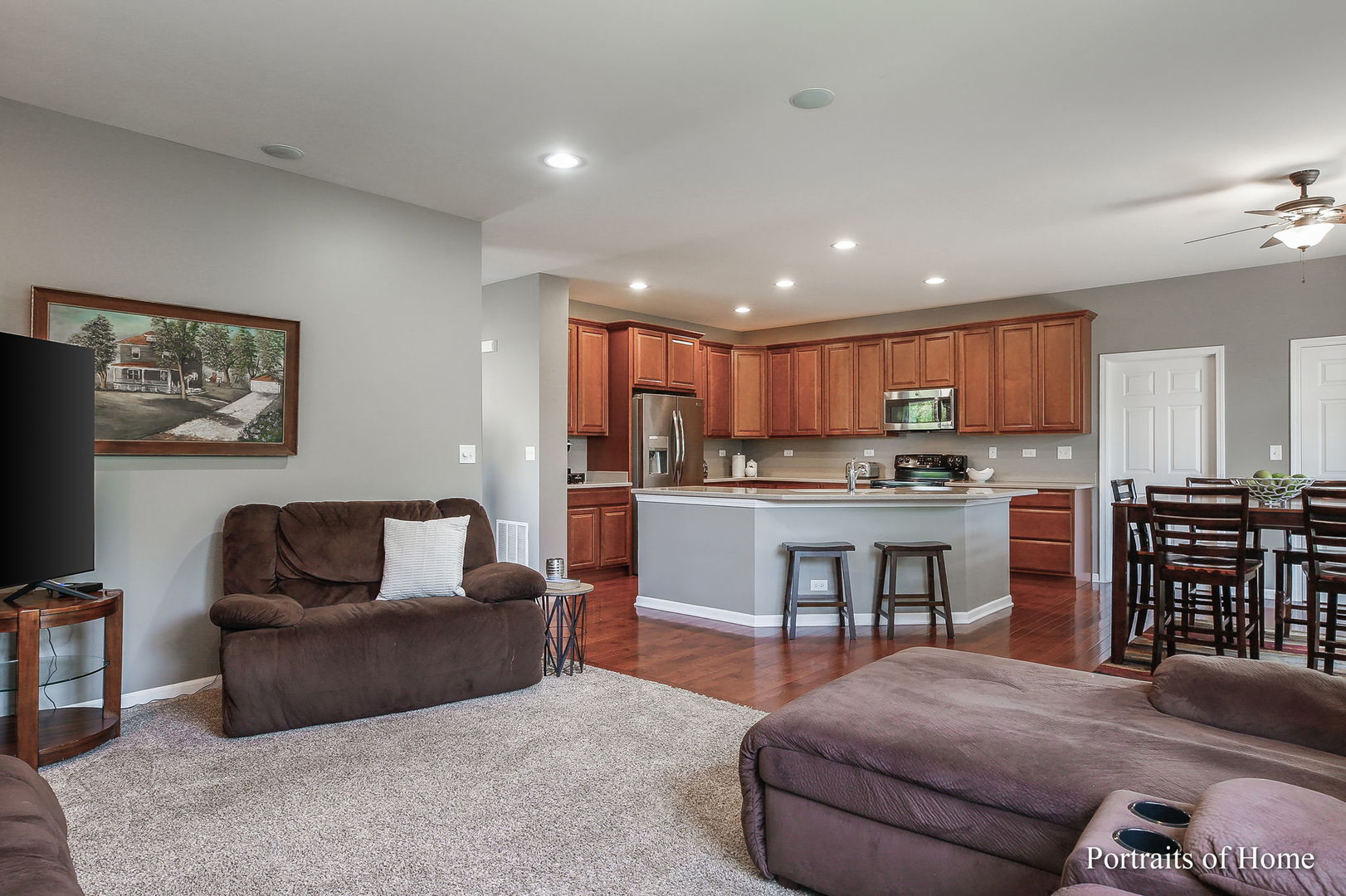 27-w030 Churchill Road Winfield, IL 60190 - Photo 13 of 28 a living room with stainless steel appliances kitchen island granite countertop furniture and a view of kitchen