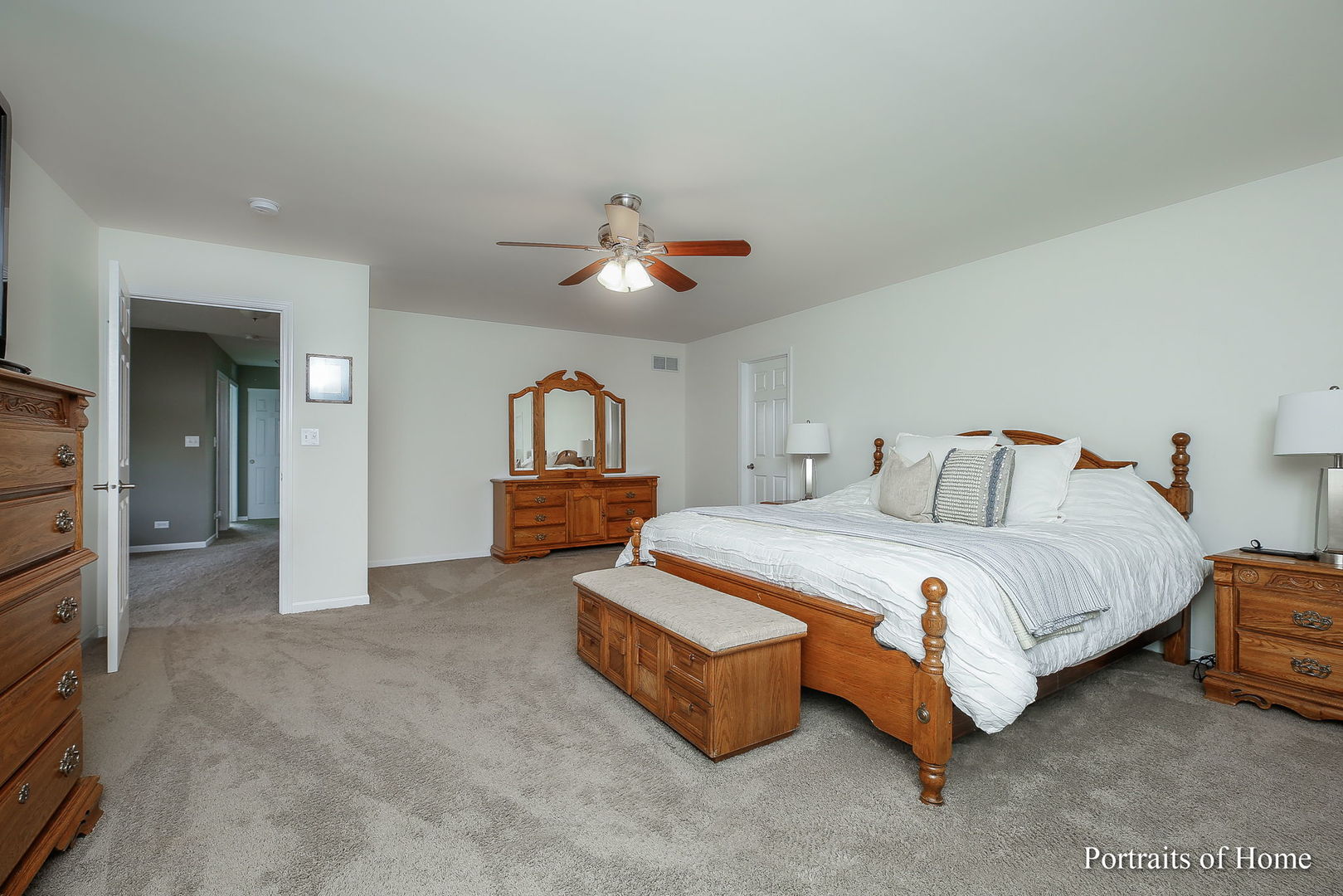 27-w030 Churchill Road Winfield, IL 60190 - Photo 19 of 28 a spacious bedroom with a bed and a chandelier