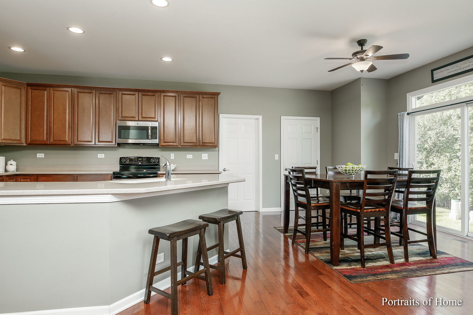 27-w030 Churchill Road Winfield, IL 60190 - Photo 7 of 28 a kitchen with stainless steel appliances kitchen island granite countertop a dining table chairs and granite counter tops