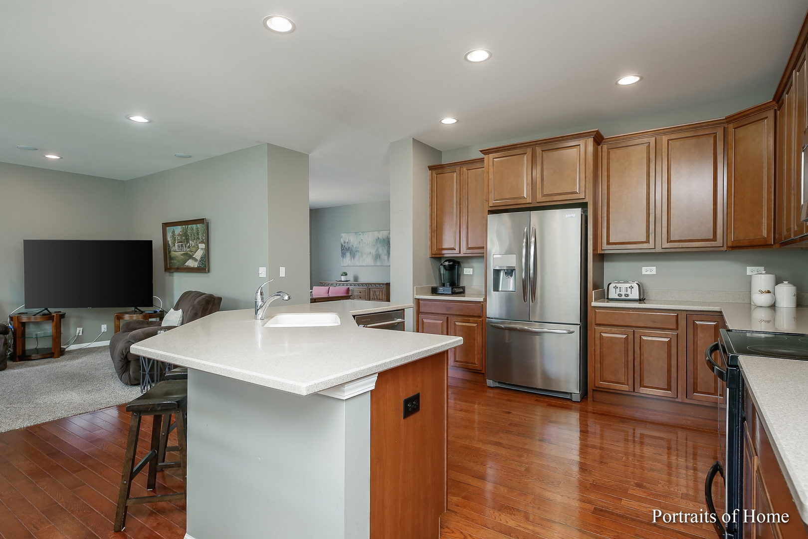 27-w030 Churchill Road Winfield, IL 60190 - Photo 8 of 28 a kitchen that has a refrigerator a stove a sink and a dining table with wooden floor