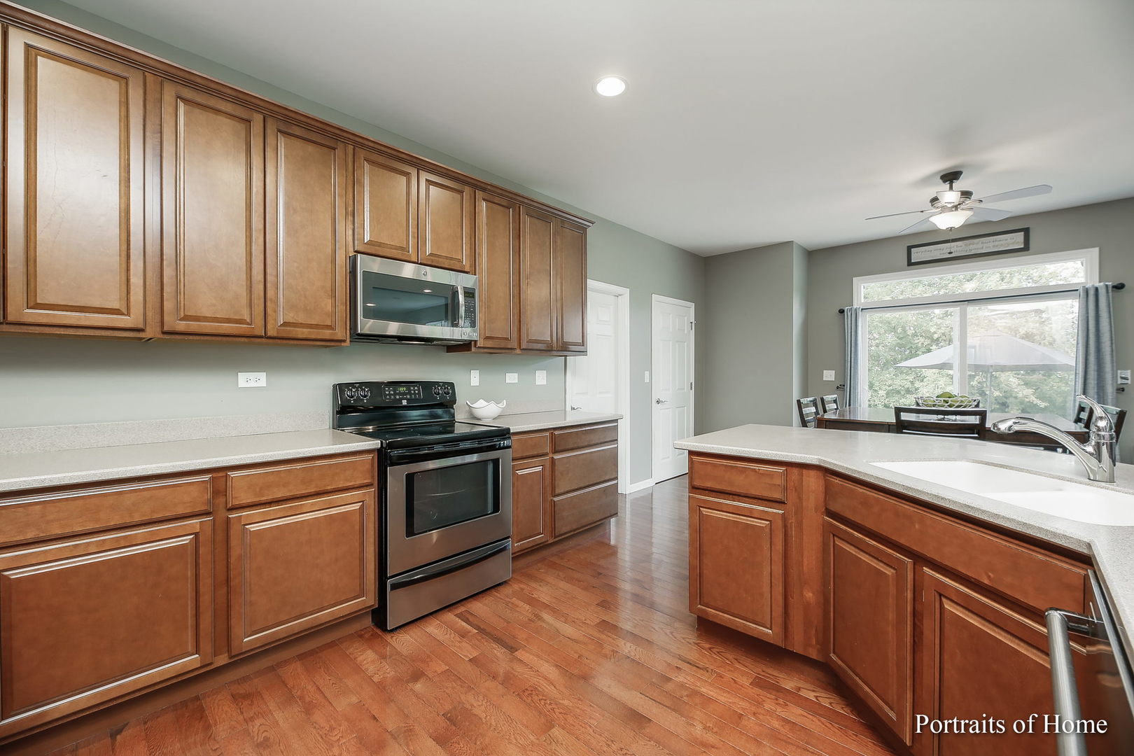 27-w030 Churchill Road Winfield, IL 60190 - Photo 9 of 28 a kitchen with granite countertop wooden cabinets stainless steel appliances and a window
