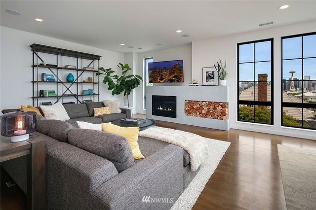 a living room with fireplace furniture and a flat screen tv