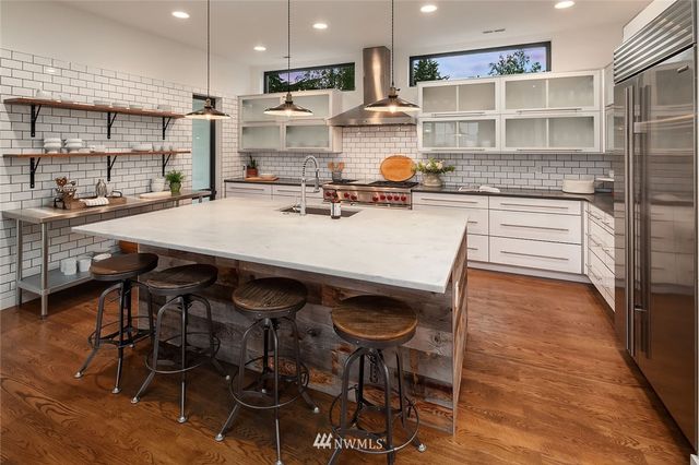 a kitchen with a table chairs stove and cabinets