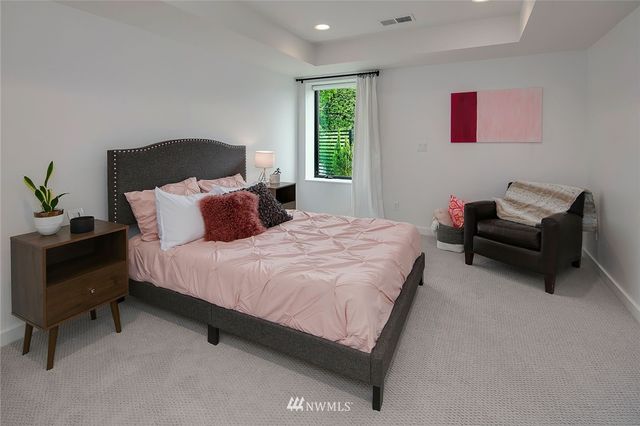 a bedroom with a bed and a couch