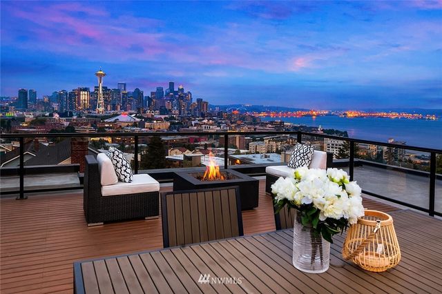 a terrace with outdoor seating and city view