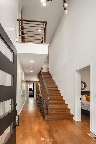 a view of entryway and hall with wooden floor