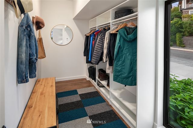a view of walk in closet with clothes and shoes