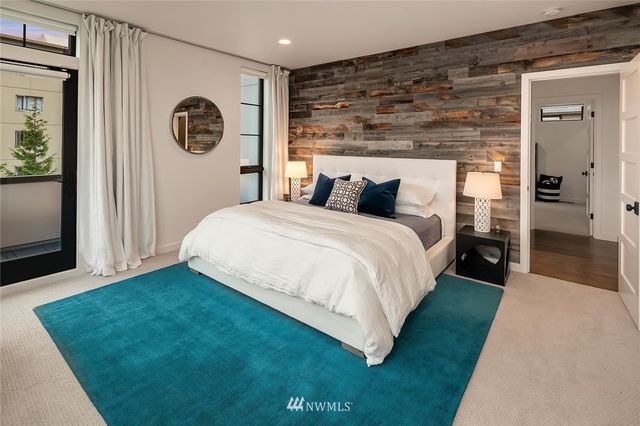 a bedroom with a bed and wall painting