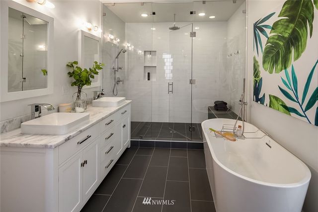 a bathroom with a granite countertop sink a toilet a tub and shower